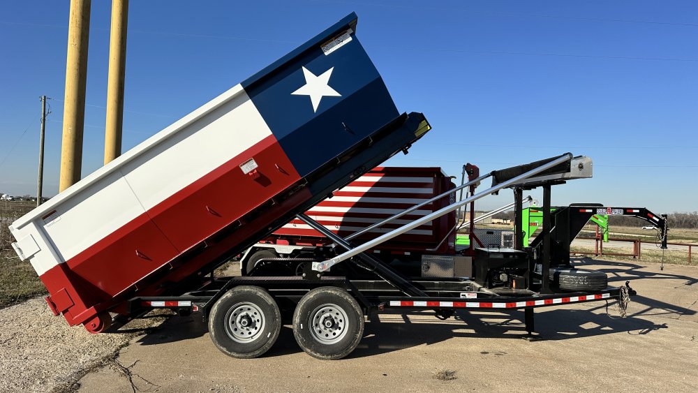 Roll off dumpster trailers on display at Dumpster Expo featuring hooklift, cable pull, and standard rail trailer systems used in the dumpster rental industry